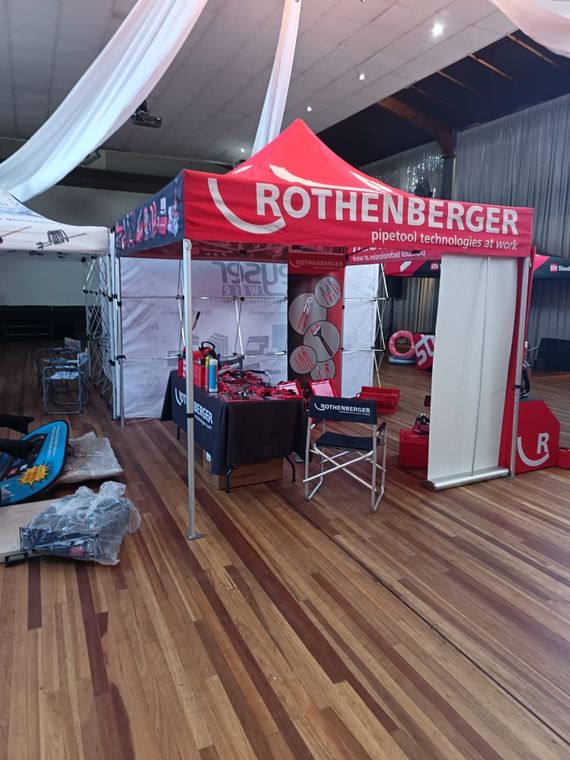 A pipe tool supplier's stand with hand tools laid out across the display tables