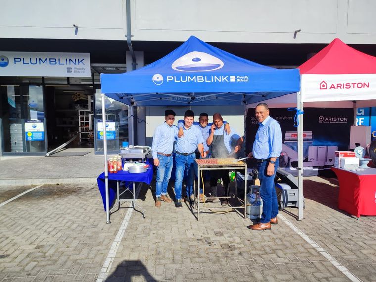 The Plumblink team gathered around a braai under their gazebo