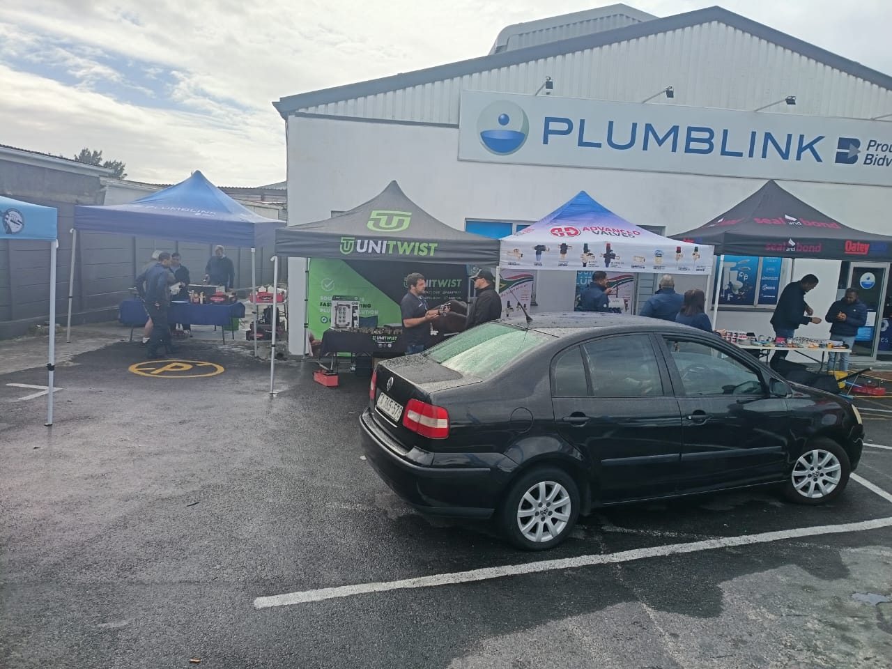 Supplier stands set up in the parking area outside a plumbing merchant