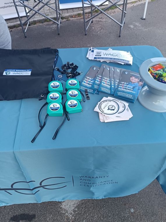 WACC tape measures, IPA membership brochures and stickers laid out on the stand table